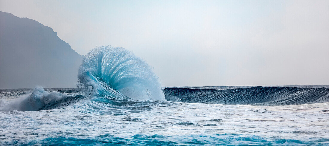 Ocean waves crashing into the shore off the Na Pali coast; Kauai, Hawaii, United States of America