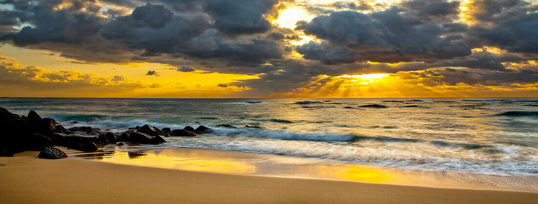 Sunrise from a beach on the coast of Kauai; Kauai, Hawaii, United States of America