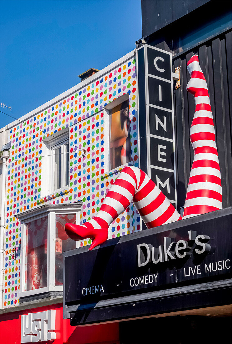 Cinema sign and colourful retail facade in North Laine, a shopping district; Brighton, East Sussex, England