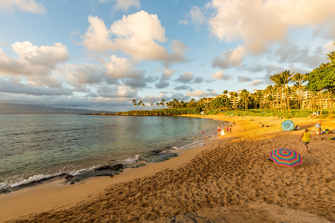 Tourists enjoying Kapalua Beach at sunset; Ka'anapali, Maui, Hawaii, United States of America