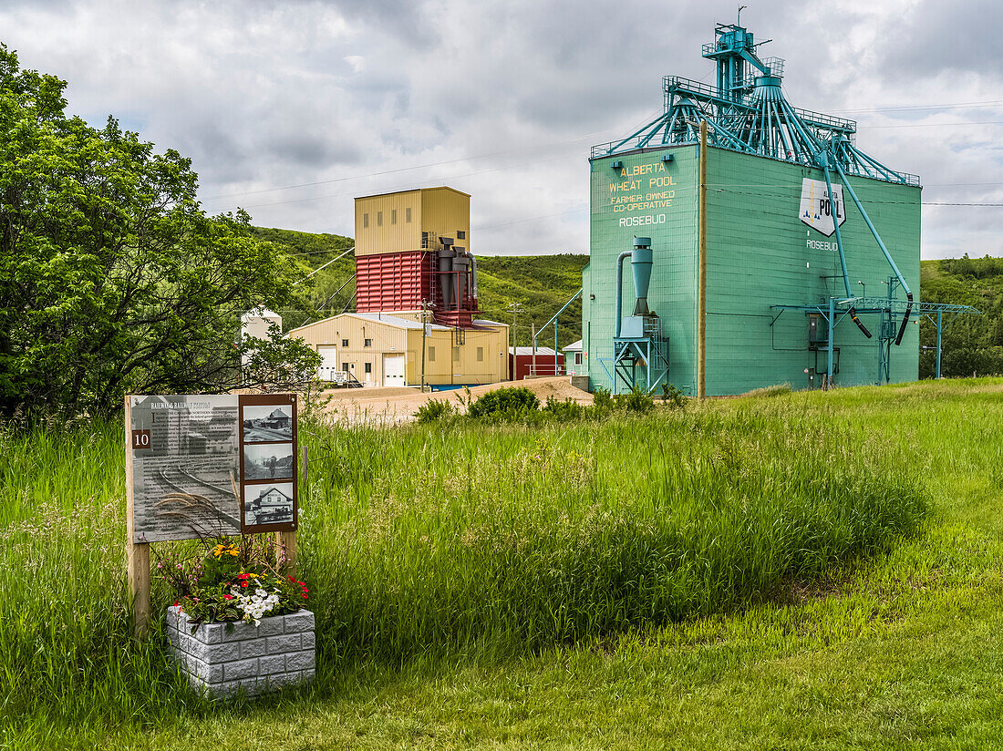 Grain elevator and sign for historical information in Rosebud, a hamlet in Southern Alberta, within Wheatland County; Alberta, Canada