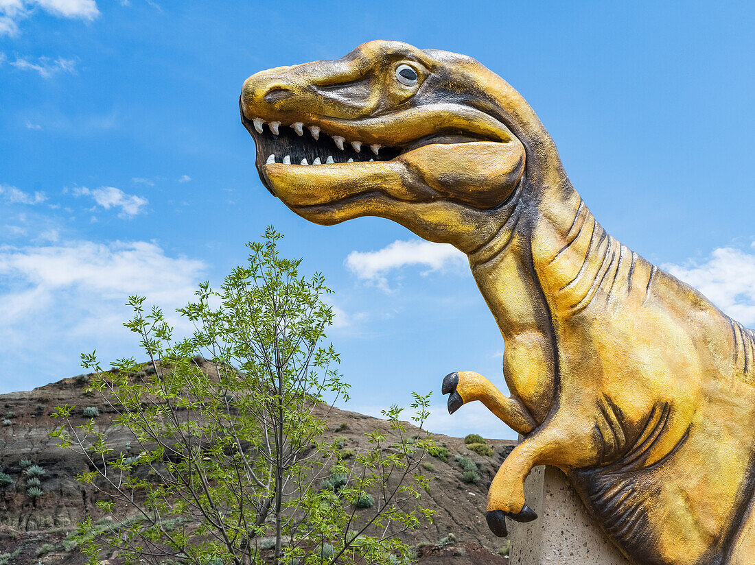 Dinosaur sculpture as part of the 'Welcome to Drumheller' sign; Drumheller, Alberta, Canada