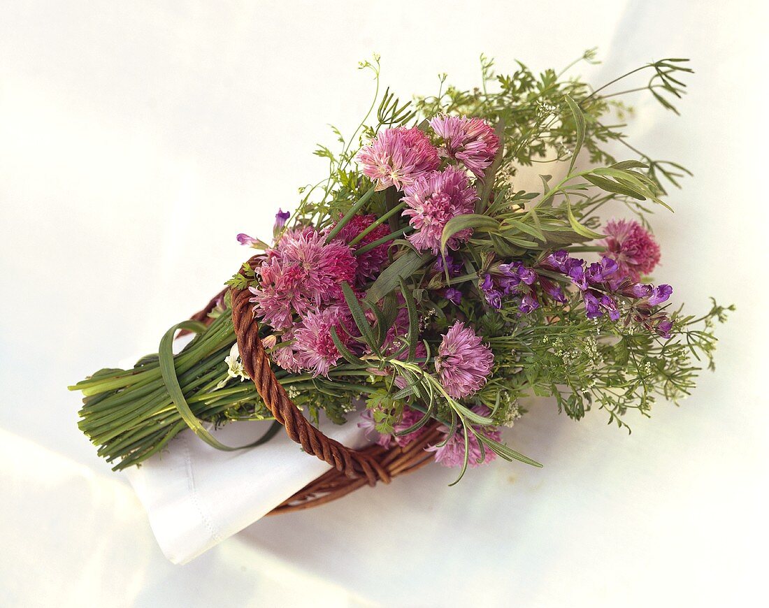 Flowering herb bouquet in willow basket