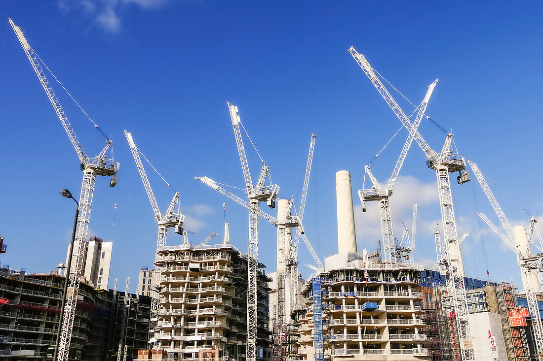 Cranes in residential development and the Power Station, Battersea; London, England