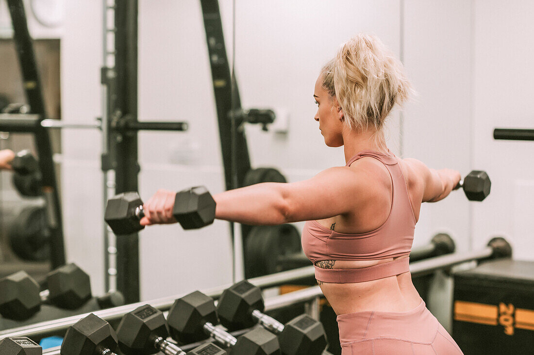 Woman working out with weights; Wellington, New Zealand