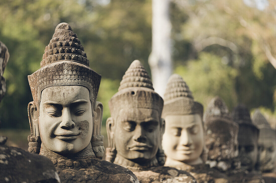 Head sculptures at South gate to Bayon temple, Angkor Wat complex; Siem  Reap, Cambodia