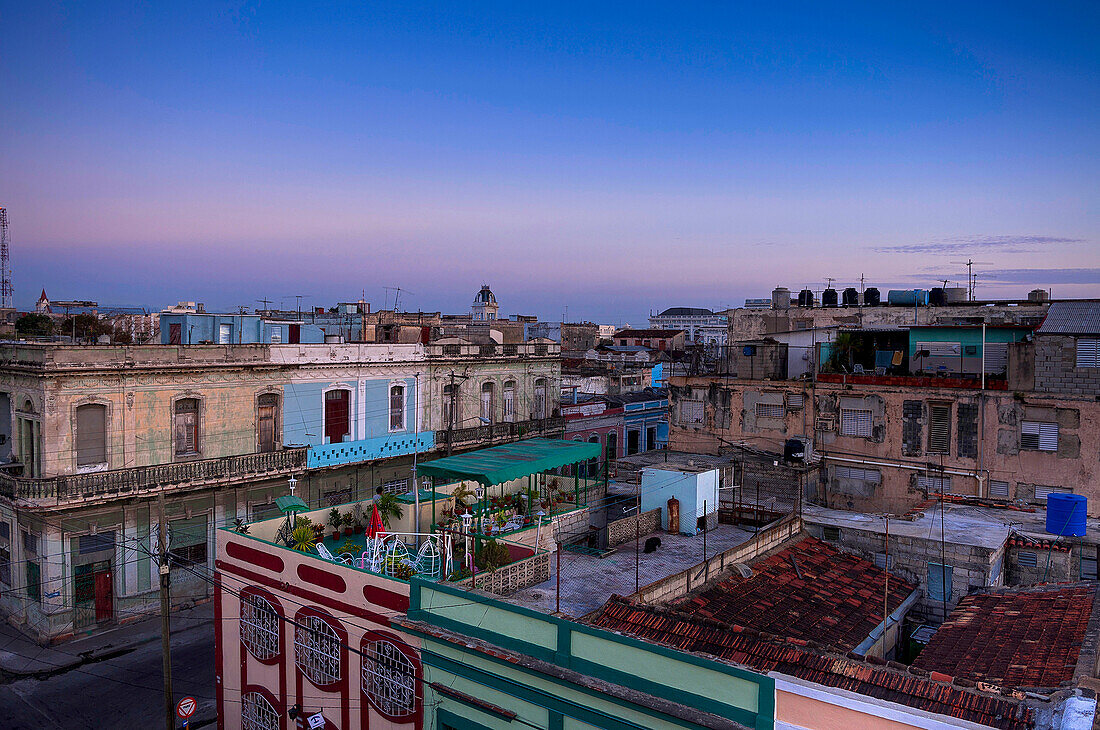 Overview of rooftops of buildings at dusk, Cienfuegos, Cuba, West Indies, Caribbean