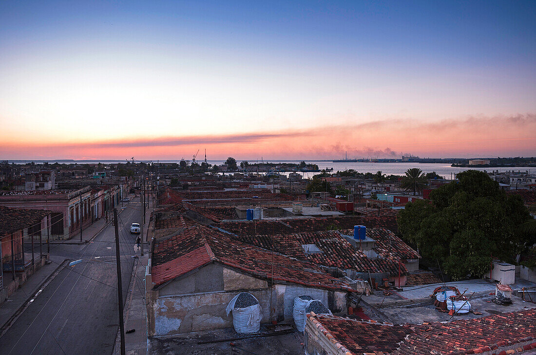 Overview of rooftops of buildings at dusk, Cienfuegos, Cuba, West Indies, Caribbean
