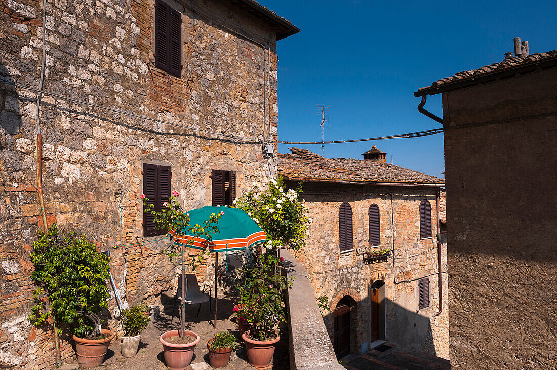 View of building with balcony garden, San Gimignano, Province of Siena, Tuscany, Italy