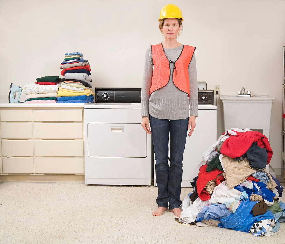 Woman Wearing Safety Vest and Hard Hat Doing the Laundry