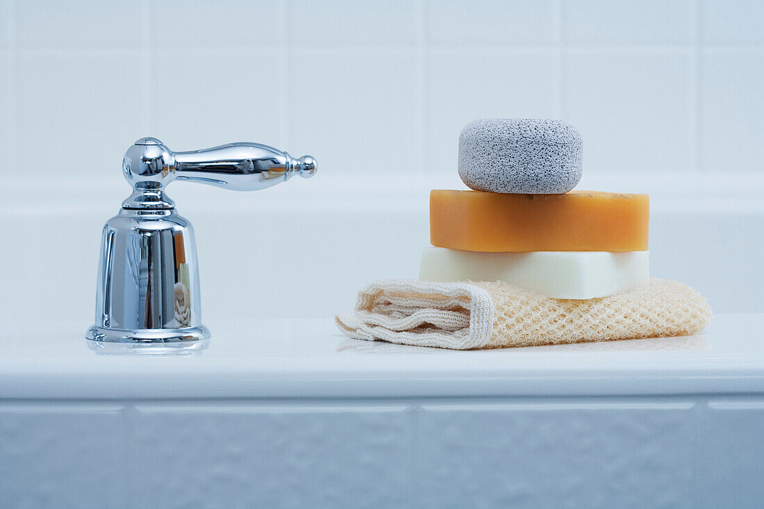 Soaps and Pumice Stone on edge of Tub