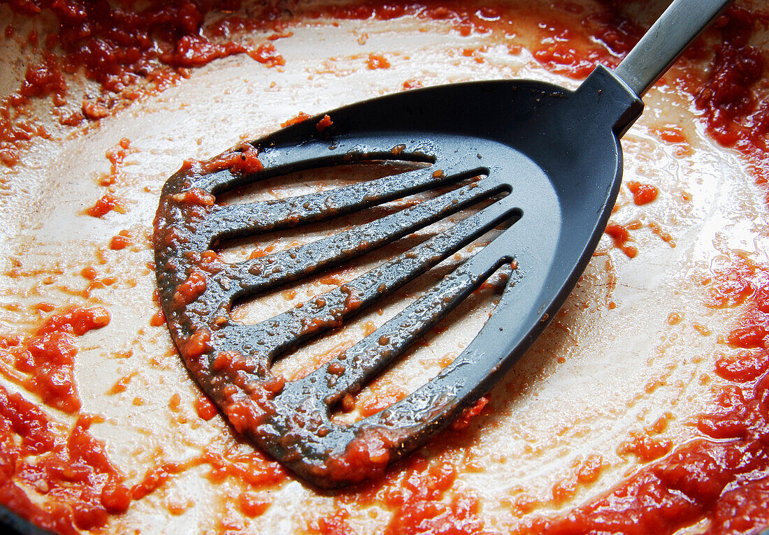 Spatula in Messy Frying Pan