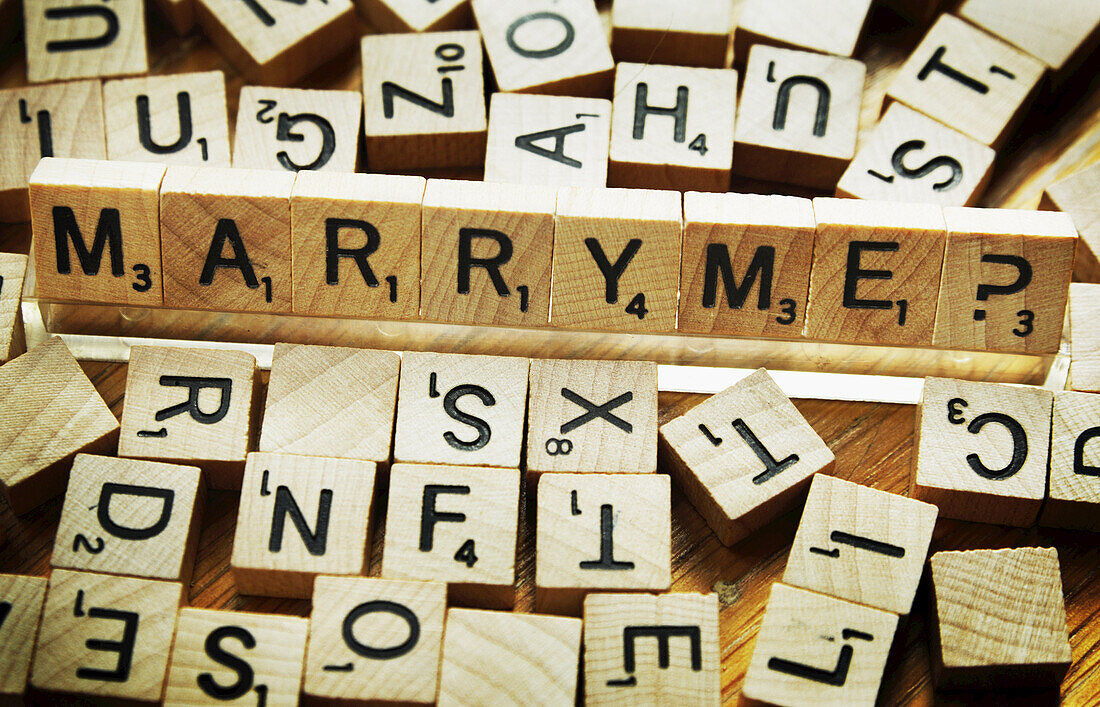 Board Game Pieces Spelling Out Marry Me