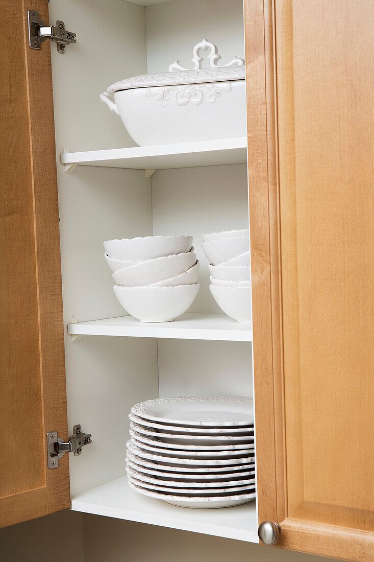 Stacked Dishes in Kitchen Cupboard