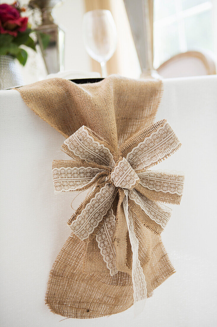 Burlap table runner and bow with elegant table setting