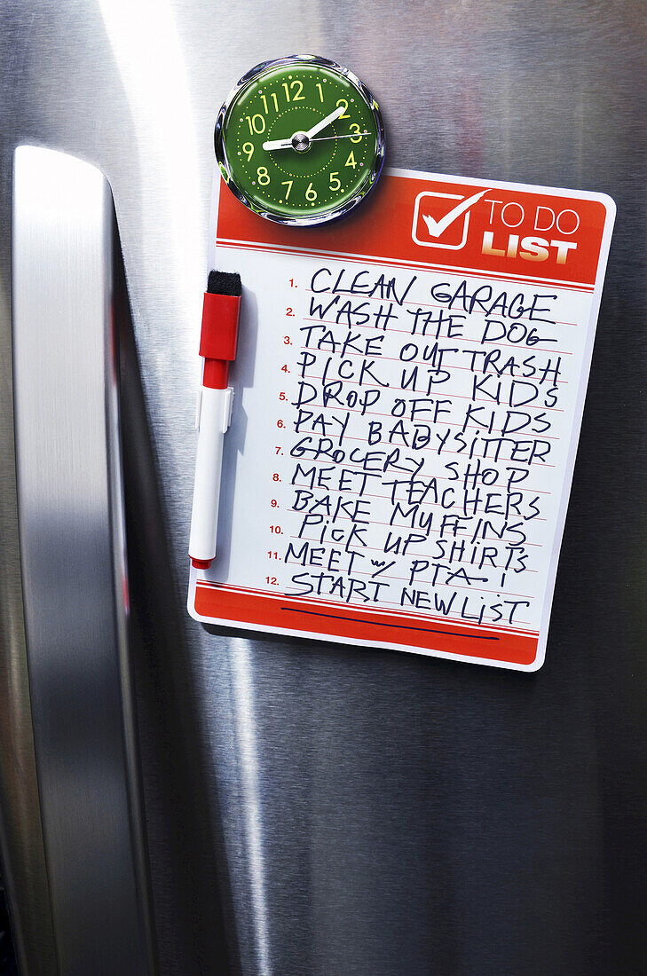 Close-up of Front of Stainless Steel Refridgerator with Magnetized To Do List