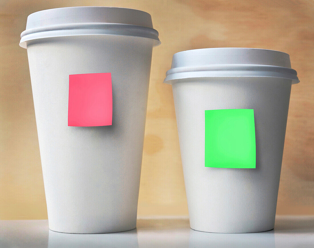 Close-up of Two Take-out Coffee Cups with Sticky Notes