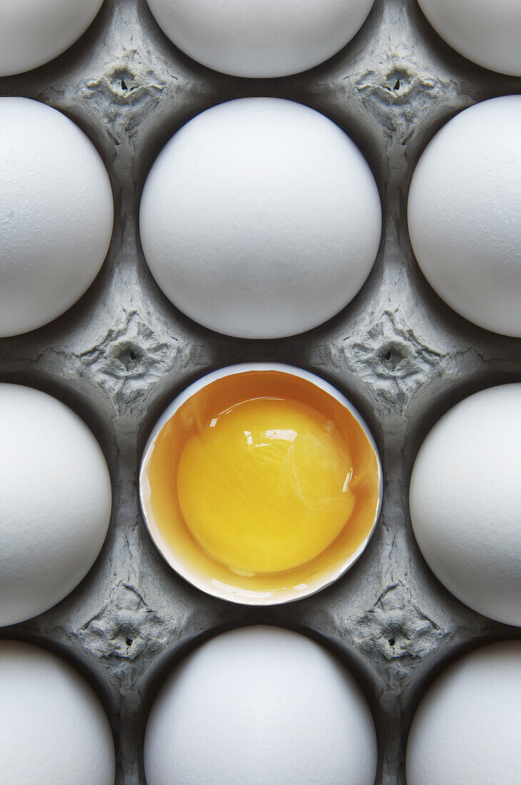 Eggs in Carton with One Broken Shell