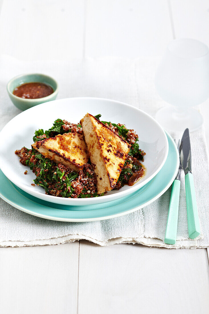 Honey ginger tofu on quinoa and kale salad, studio shot