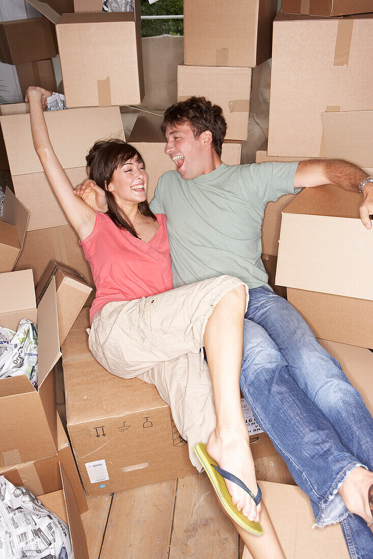 Couple Sitting Amongst Moving Boxes