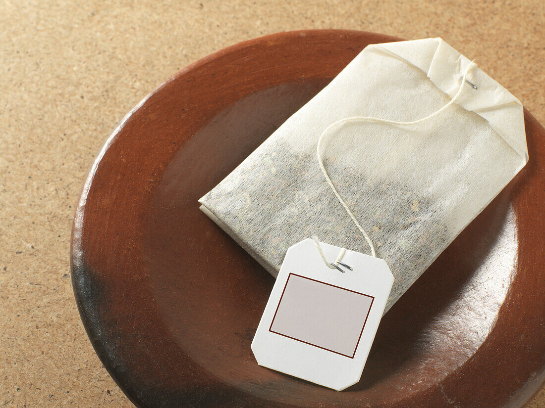 Close-up of Teabag on Plate, Studio Shot