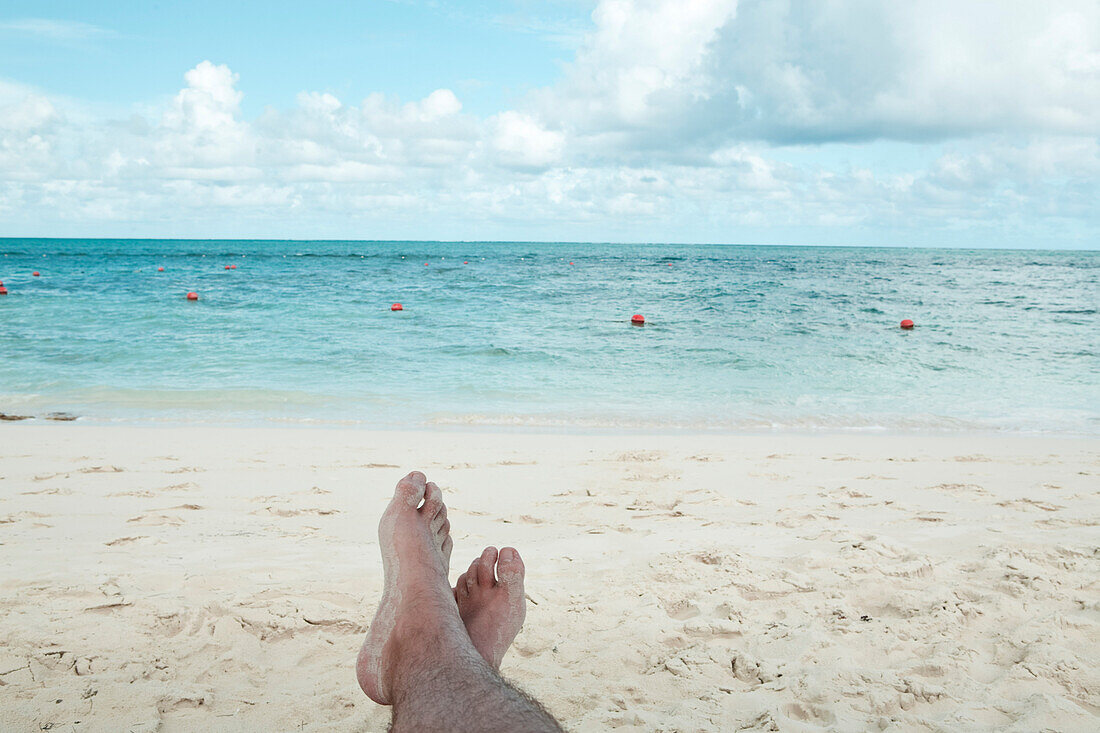 Mann faulenzt am Strand, Turks- und Caicosinseln