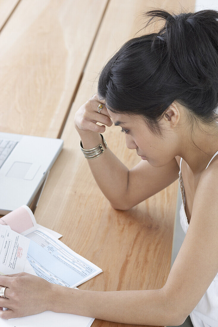 Woman Looking at Bills