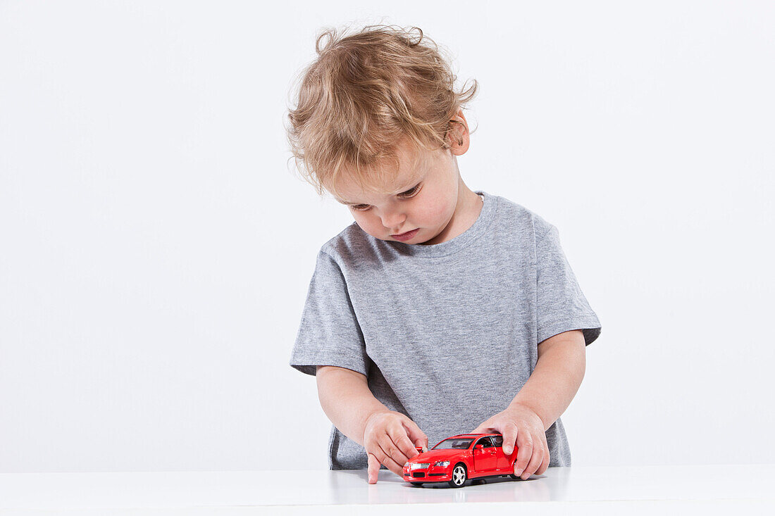 Boy Playing with Car