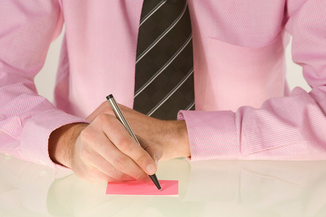 Businessman Writing on Sticky Note