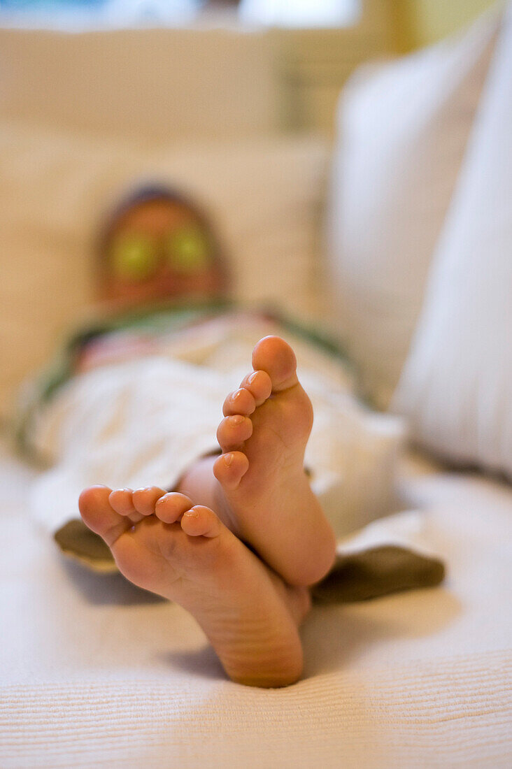 Barefoot Child Lying on Sofa, Salzburg, Austria