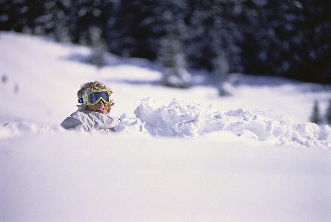 Snowboarder sitzend im Schnee, Jungfrau Region, Schweiz