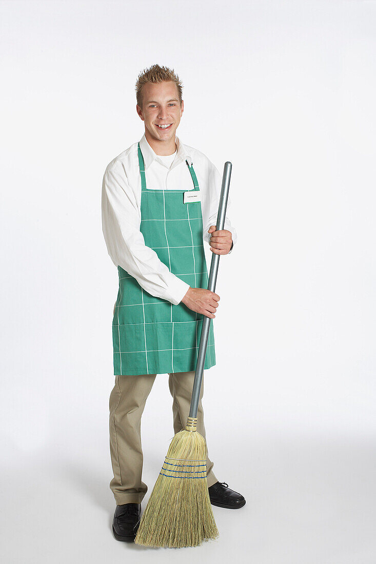 Portrait of Grocery Clerk Holding a Broom