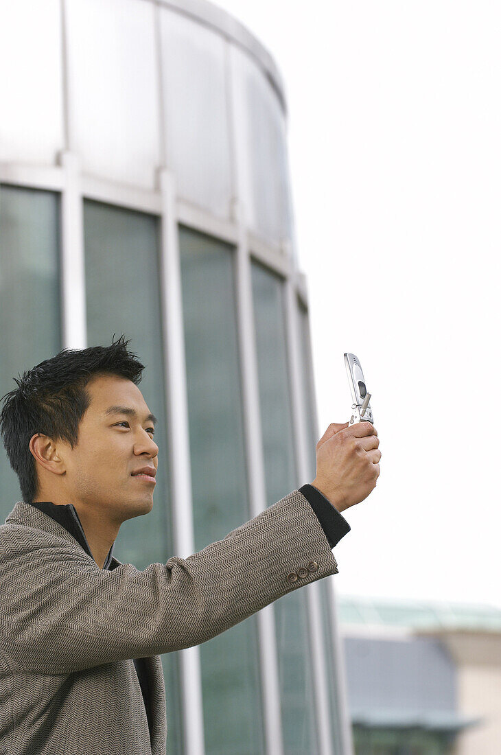 Man Taking Photo With Cell Phone