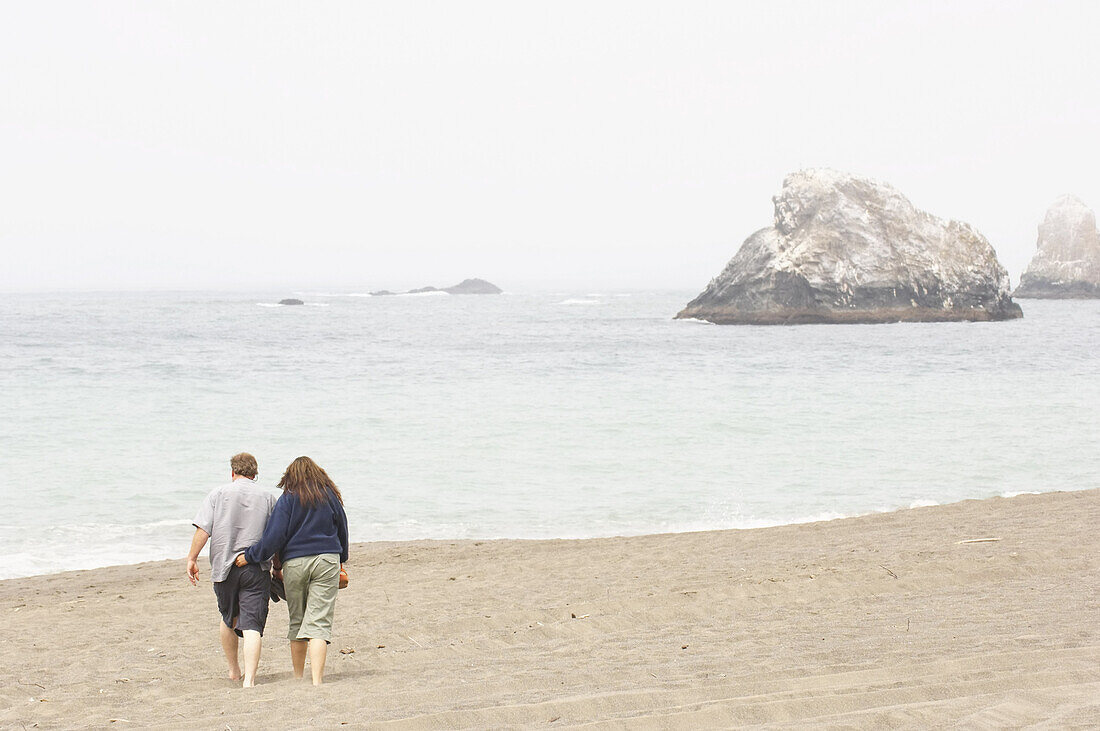 Couple Walking on Beach, Sonoma Coast, California, USA