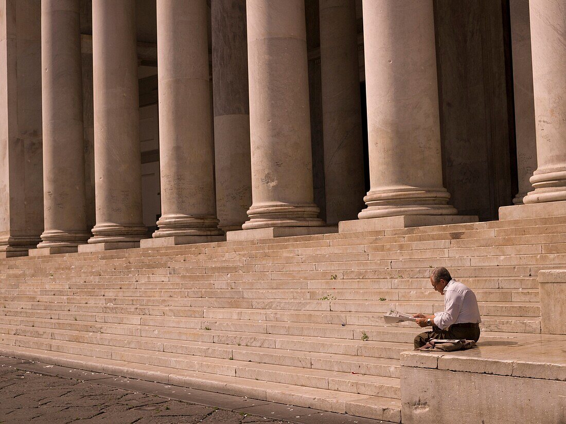 Man Readning Newspaper, Stairs With Columns In Background; Naples, Italy