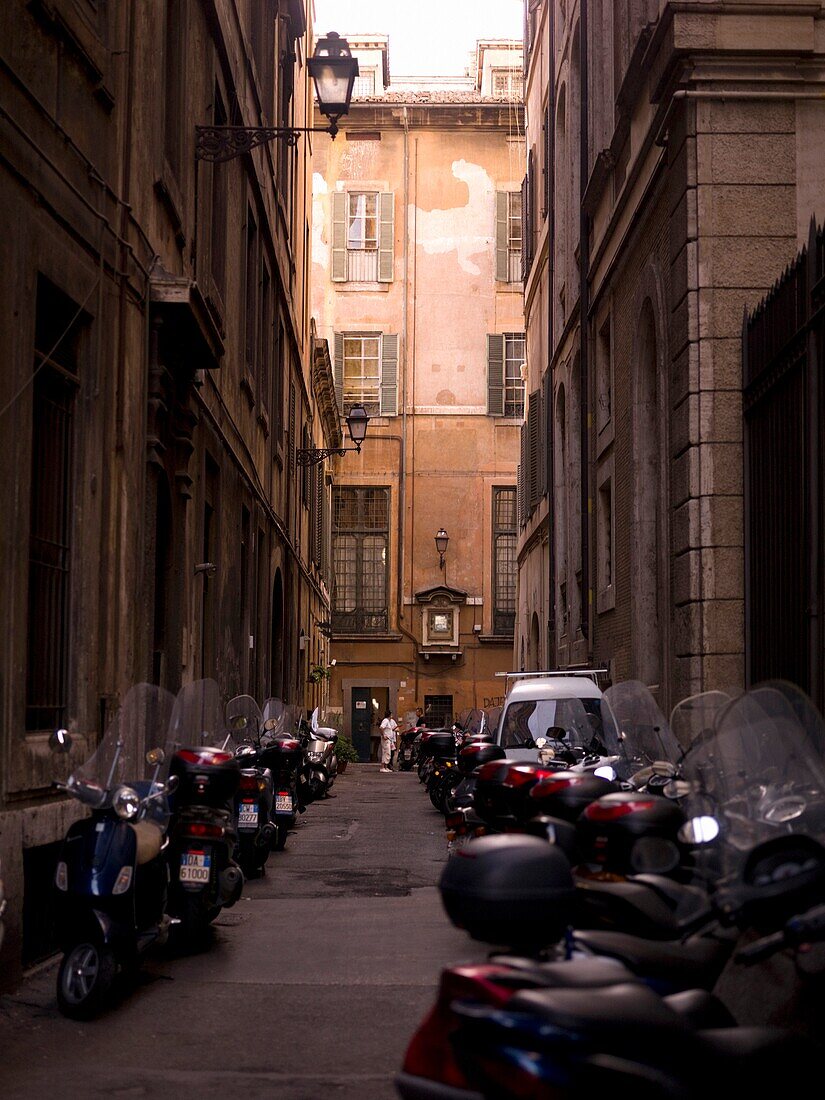 Motorcycles Parked On The Sidewalks Of Old Town; Rome, Italy