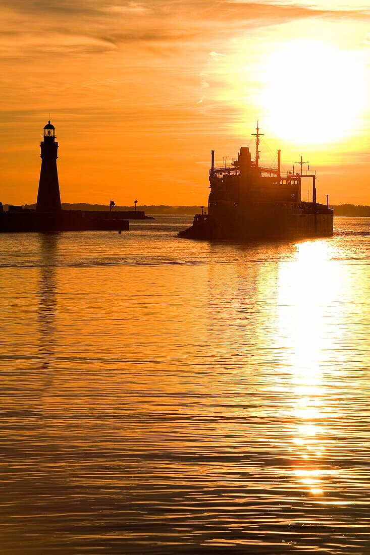 Buffalo Lighthouse And Cement Carrier In Buffalo Port At Sunset; Buffalo, New York State, Usa