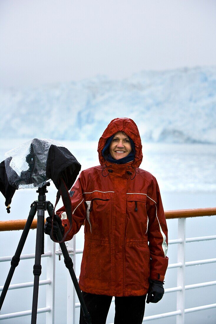 Hubbard Glacier, Alaska, Usa; Female Photographer Shooting Glacier From Boat