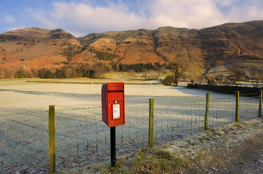 Red Mailbox On Roadside, Fields In Background; Cumbria, England, Uk