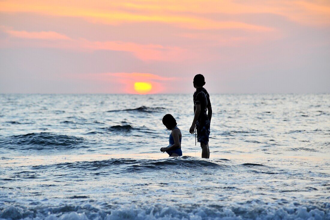Two Children In The Water At A Beach