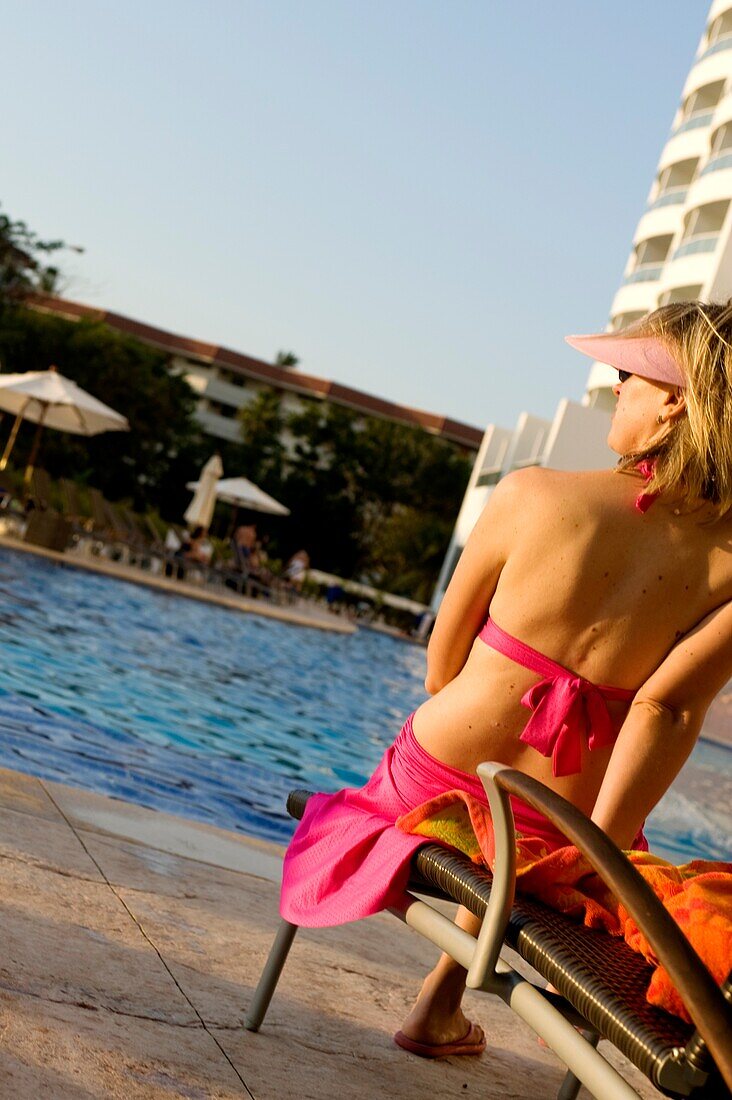 Woman Sitting Poolside