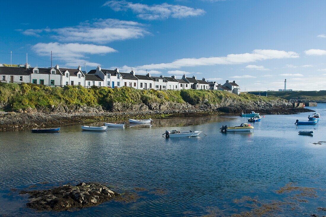 Small Boats In The Water Near Houses; Island Of Islay,Scotland