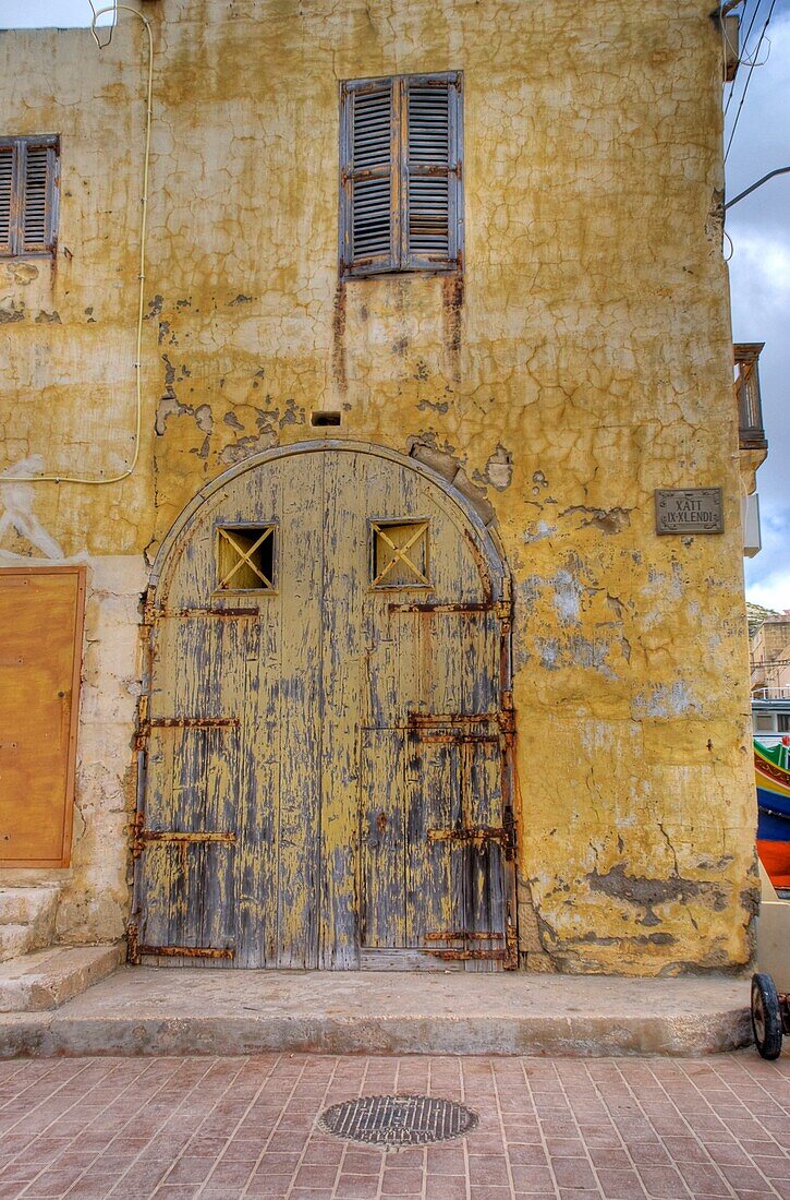 A Worn Wood Door On An Old Building