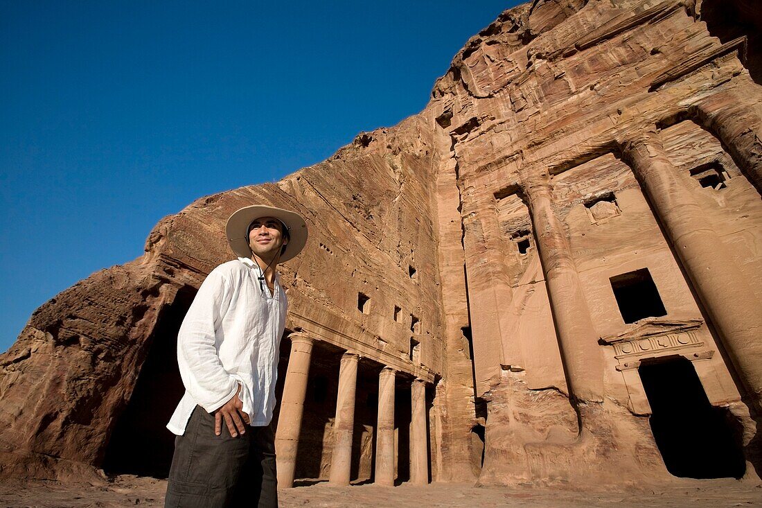 Man Standing By Royal Tomb In Petra
