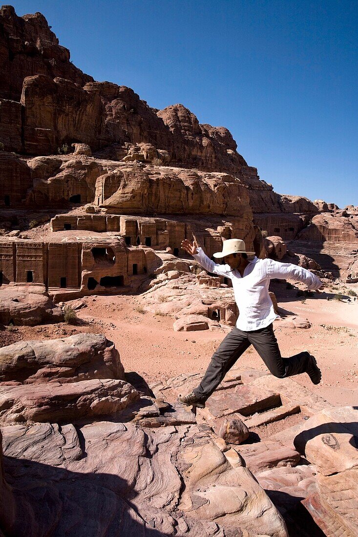 Man Jumping Near Monumental Nabataean Tombs