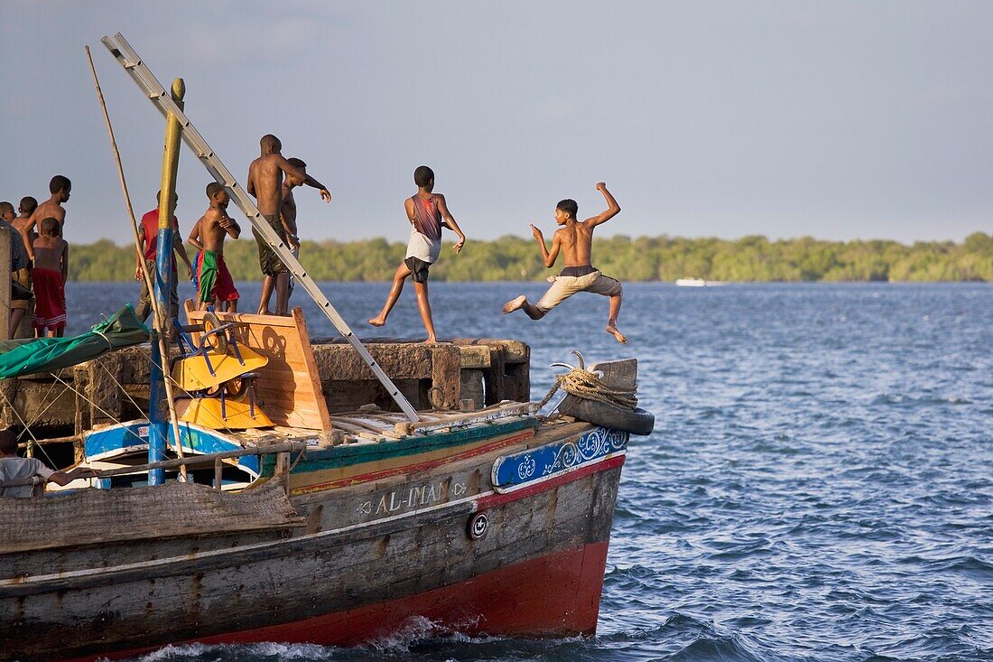 Young Boys Jumping Into The Sea Off Jetty; Lamu, Kenya