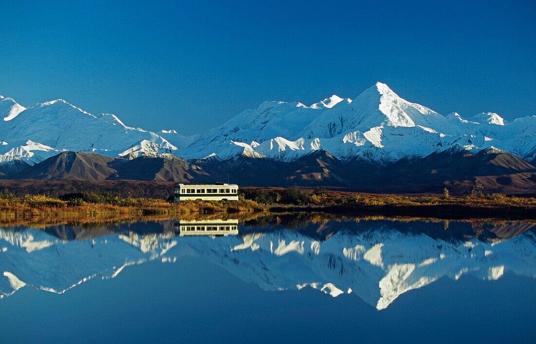 Bus Passes By Tundra Pond With Reflection Of The Alaska Range; Alaska,Usa