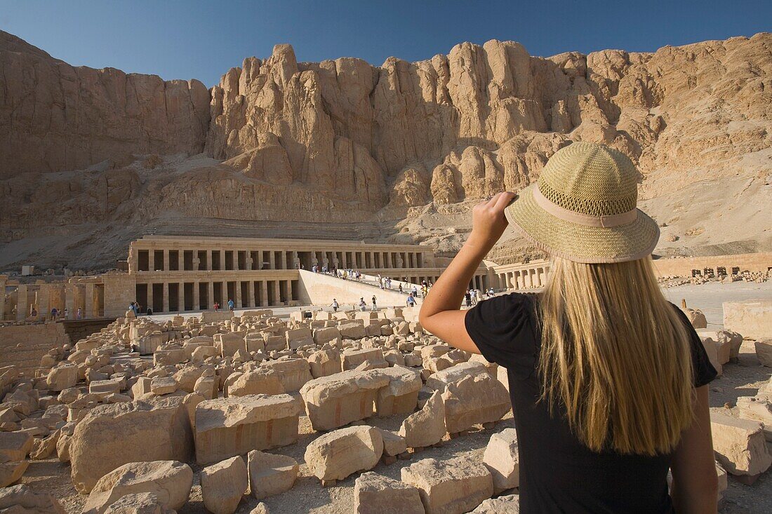 Woman Tourist Gazes At The Temple Of Hapshepsut; Nile Valley, Egypt, Africa