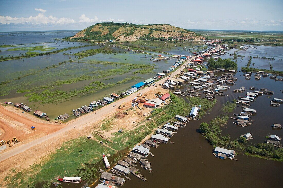 Aerial View Of The Floating Village Of Chong Kneas With The Phnom Krom Temple Located Atop The Hill In Background.