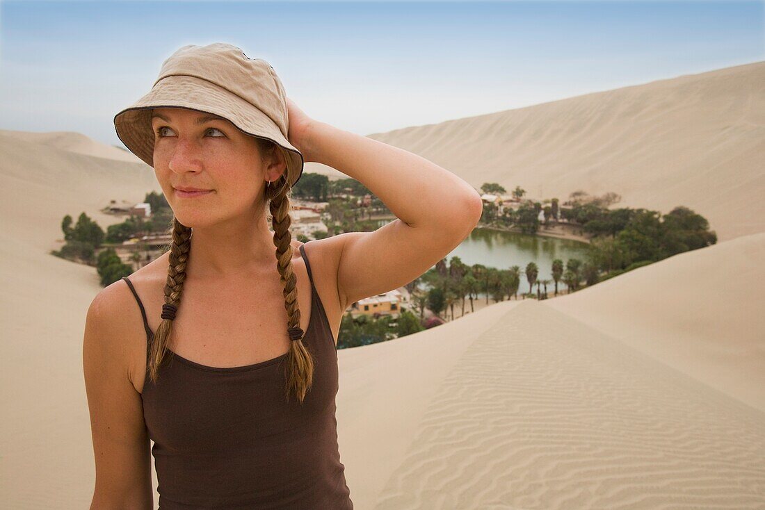 Woman In Hat In Sand Dunes, Huacachina Oasis; Huacachina Oasis, Peru